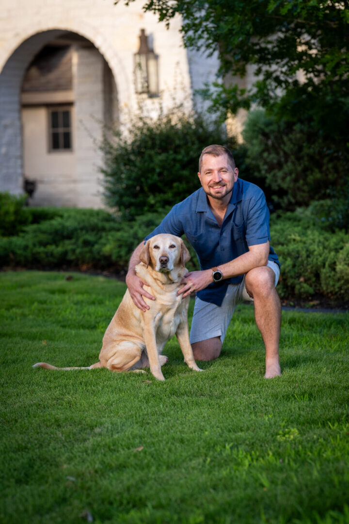 Man kneeling beside his dog