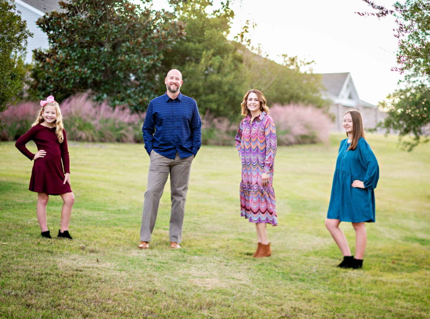 Family posing in a grassy field