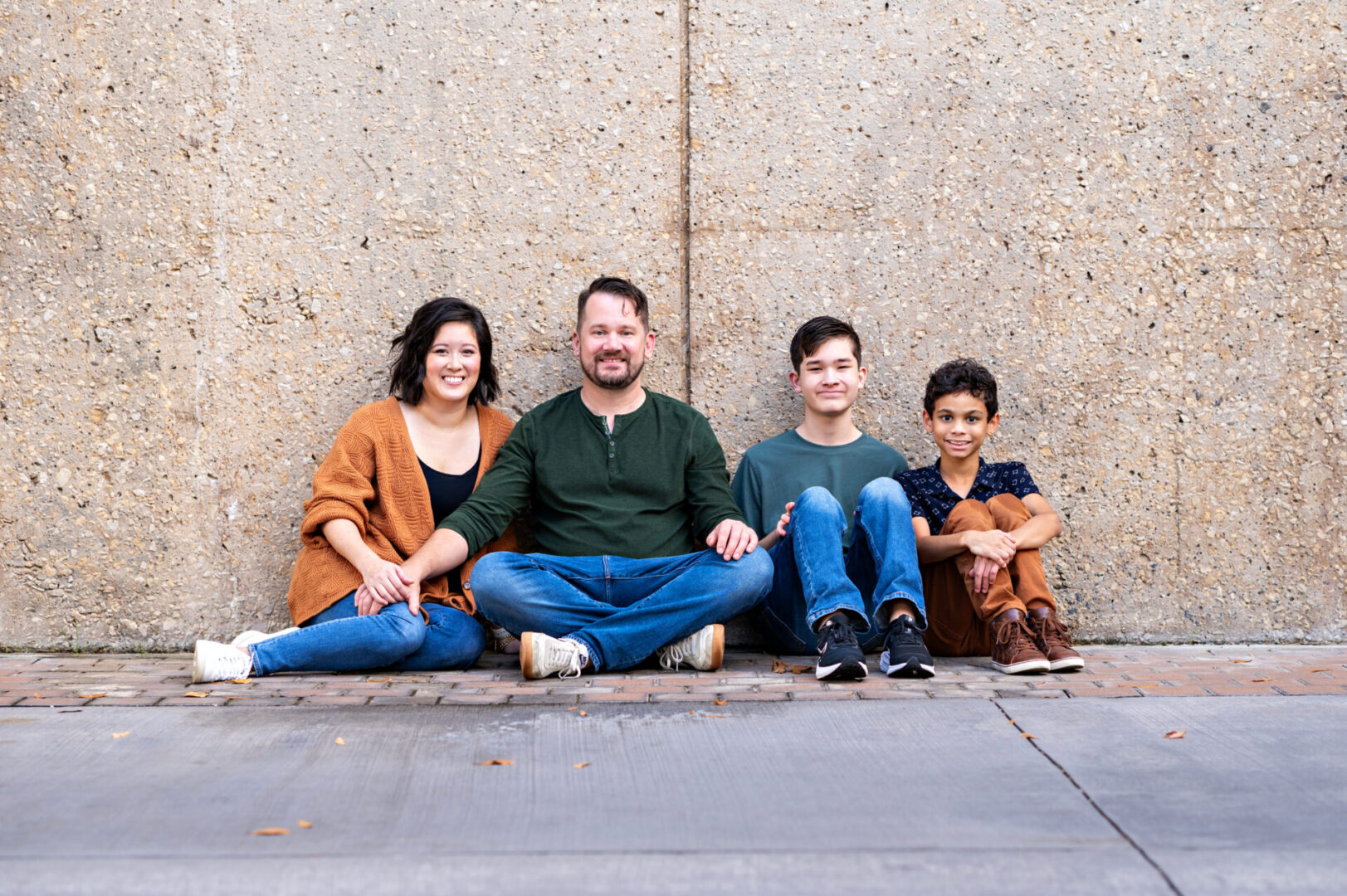 Group of four sitting on pavement