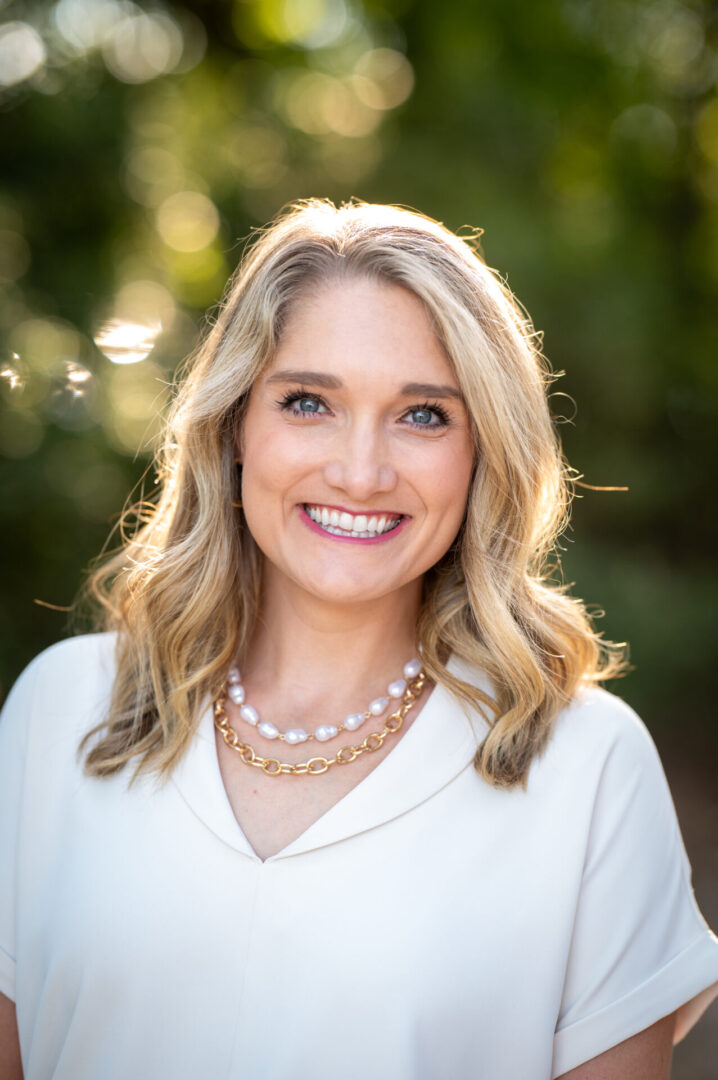 Woman with blonde hair and necklace