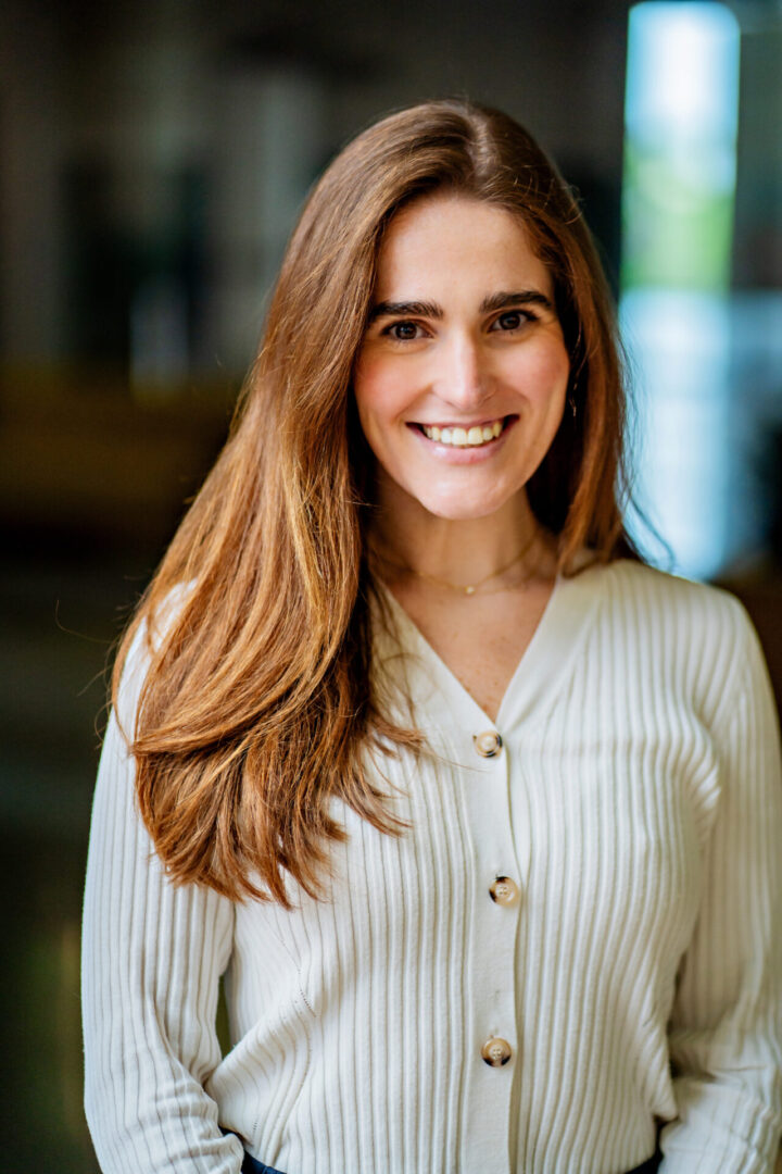 Smiling woman in a ribbed cardigan