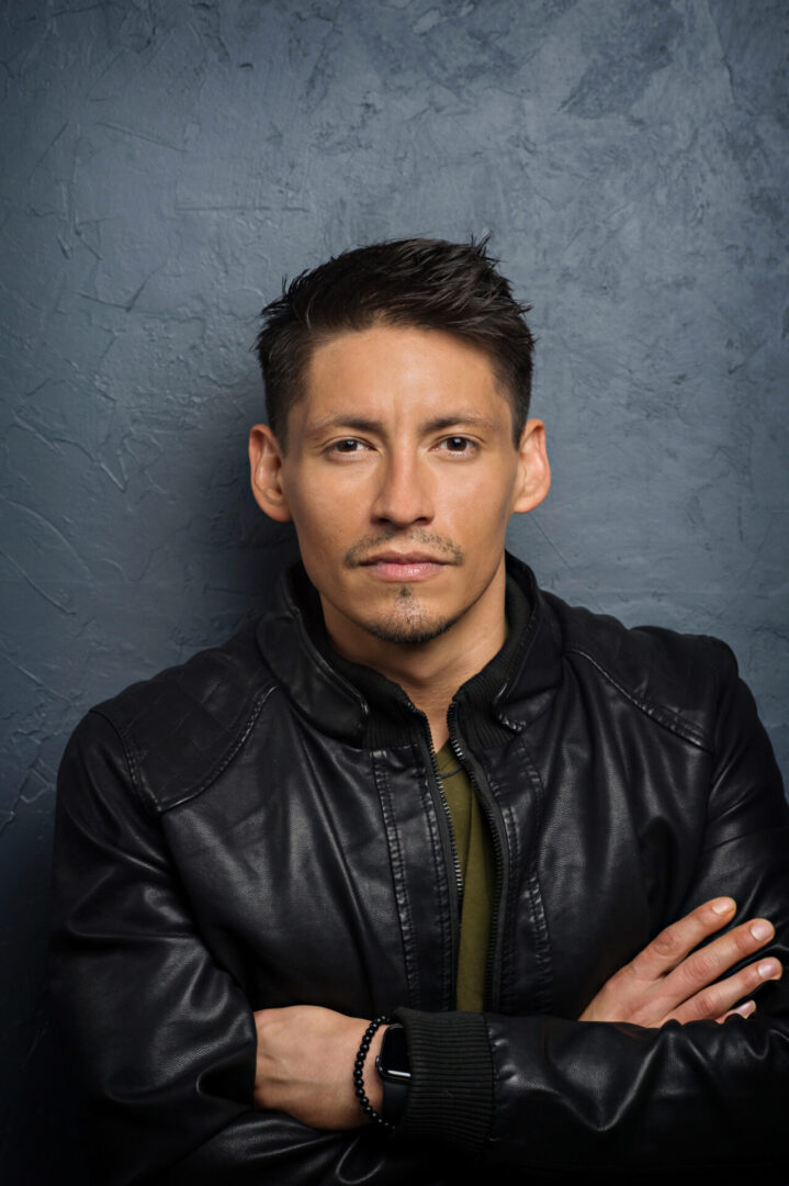 Confident man posing against textured wall