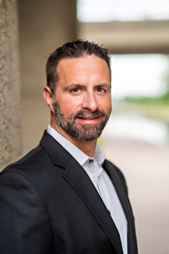 Man in suit smiling outdoors