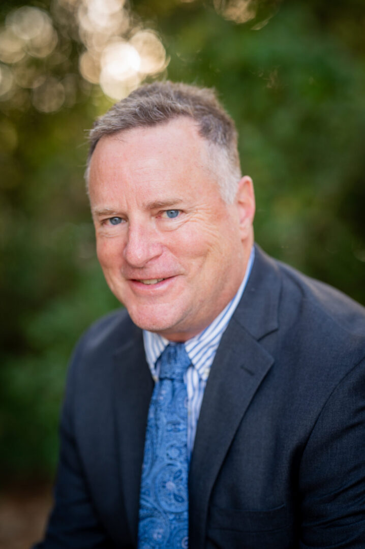 Smiling man in a suit outdoors