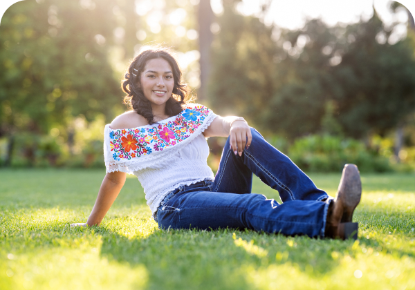 Smiling woman outdoors in colorful top.